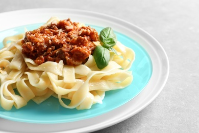 Photo of Plate with delicious pasta bolognese on table, closeup