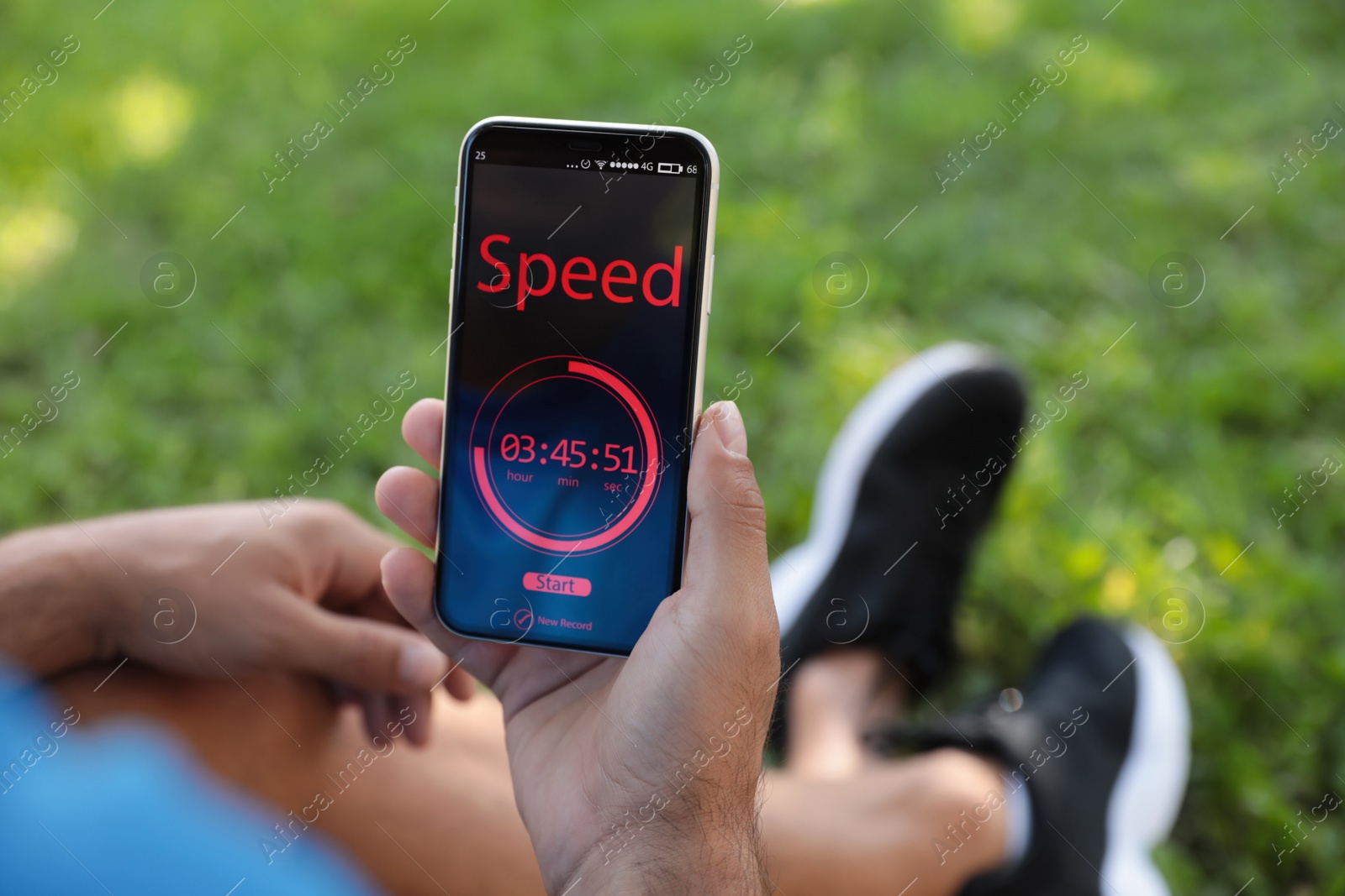 Photo of Man using fitness app on smartphone outdoors, closeup