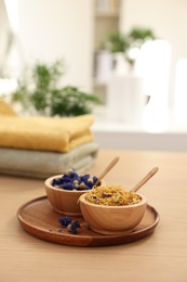 Photo of Dry flowers on wooden table indoors, space for text. Spa time