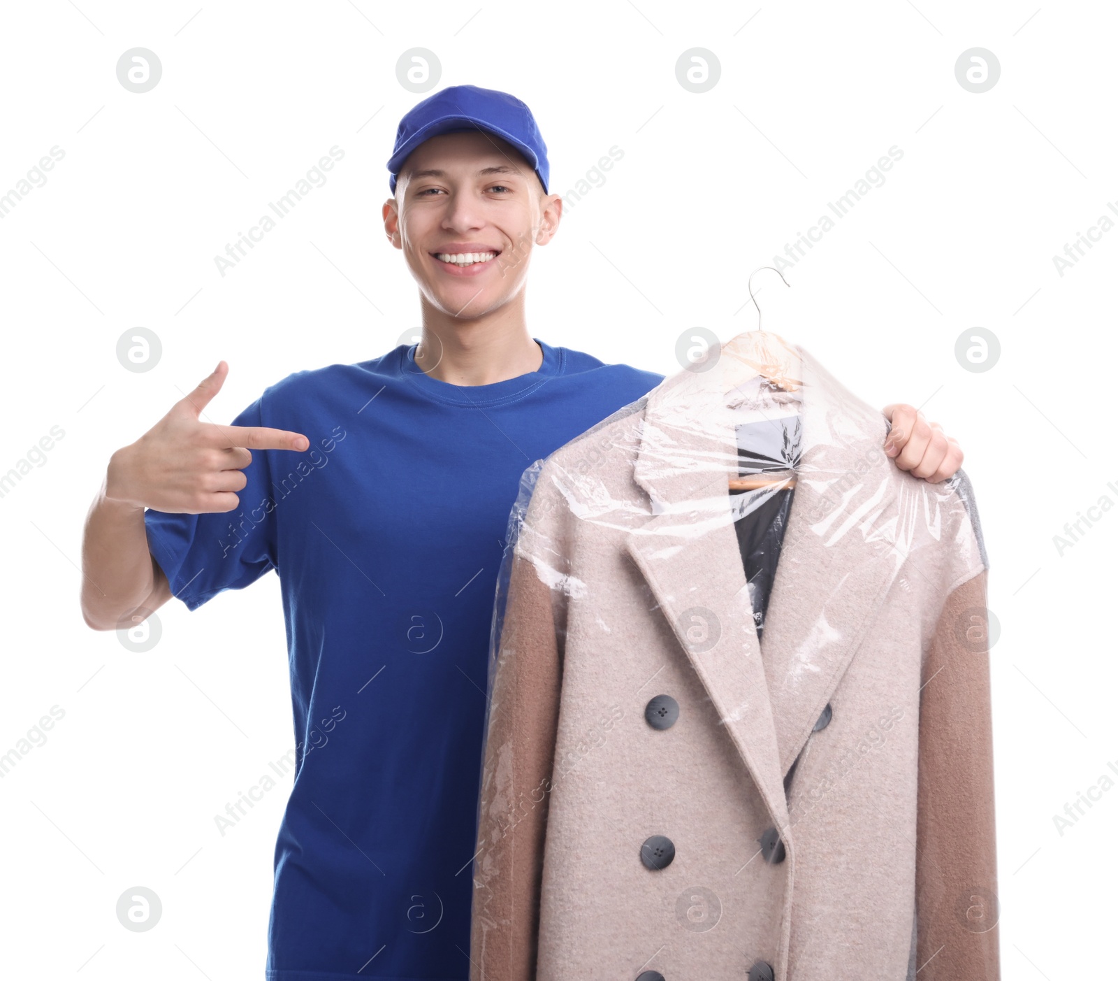 Photo of Dry-cleaning delivery. Happy courier holding coat in plastic bag on white background