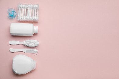 Photo of Flat lay composition with baby care products and accessories on pink background, space for text