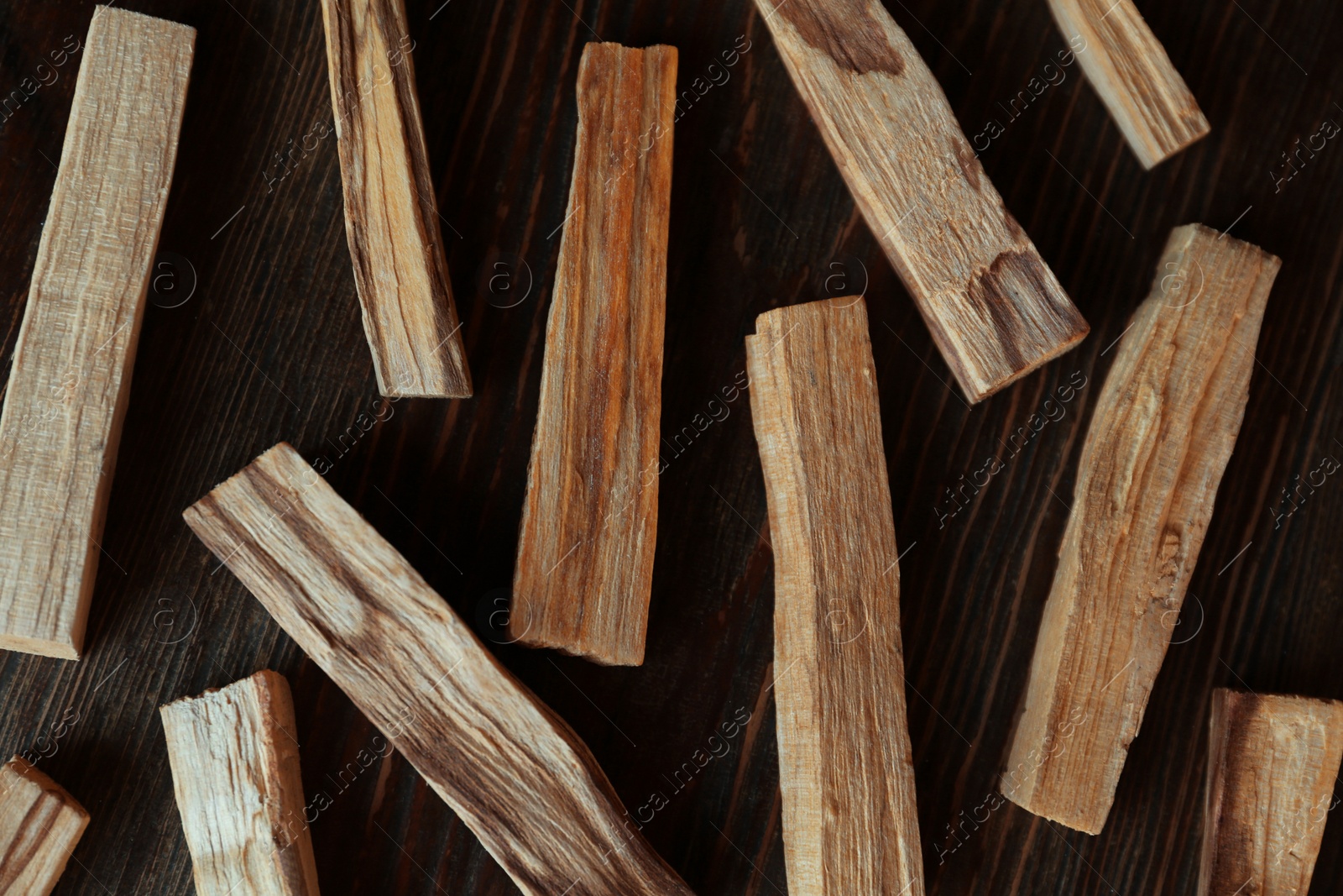 Photo of Palo santo sticks on wooden table, flat lay