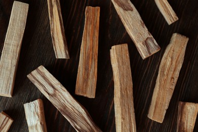 Palo santo sticks on wooden table, flat lay