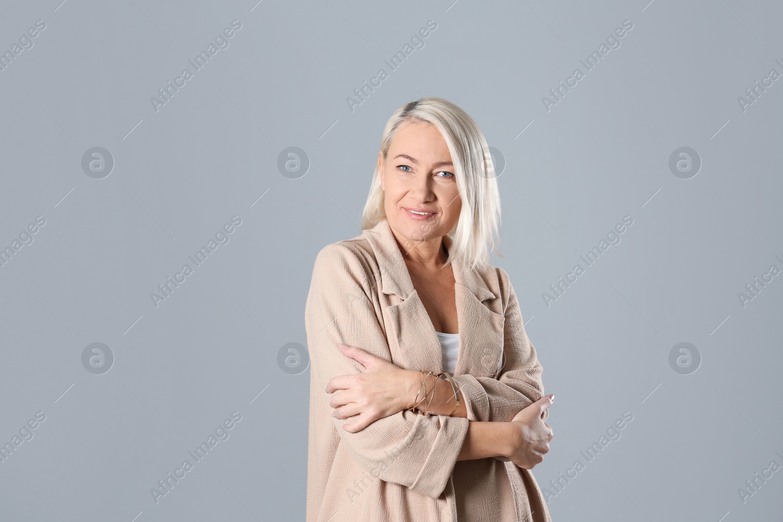 Photo of Portrait of beautiful mature woman on grey background