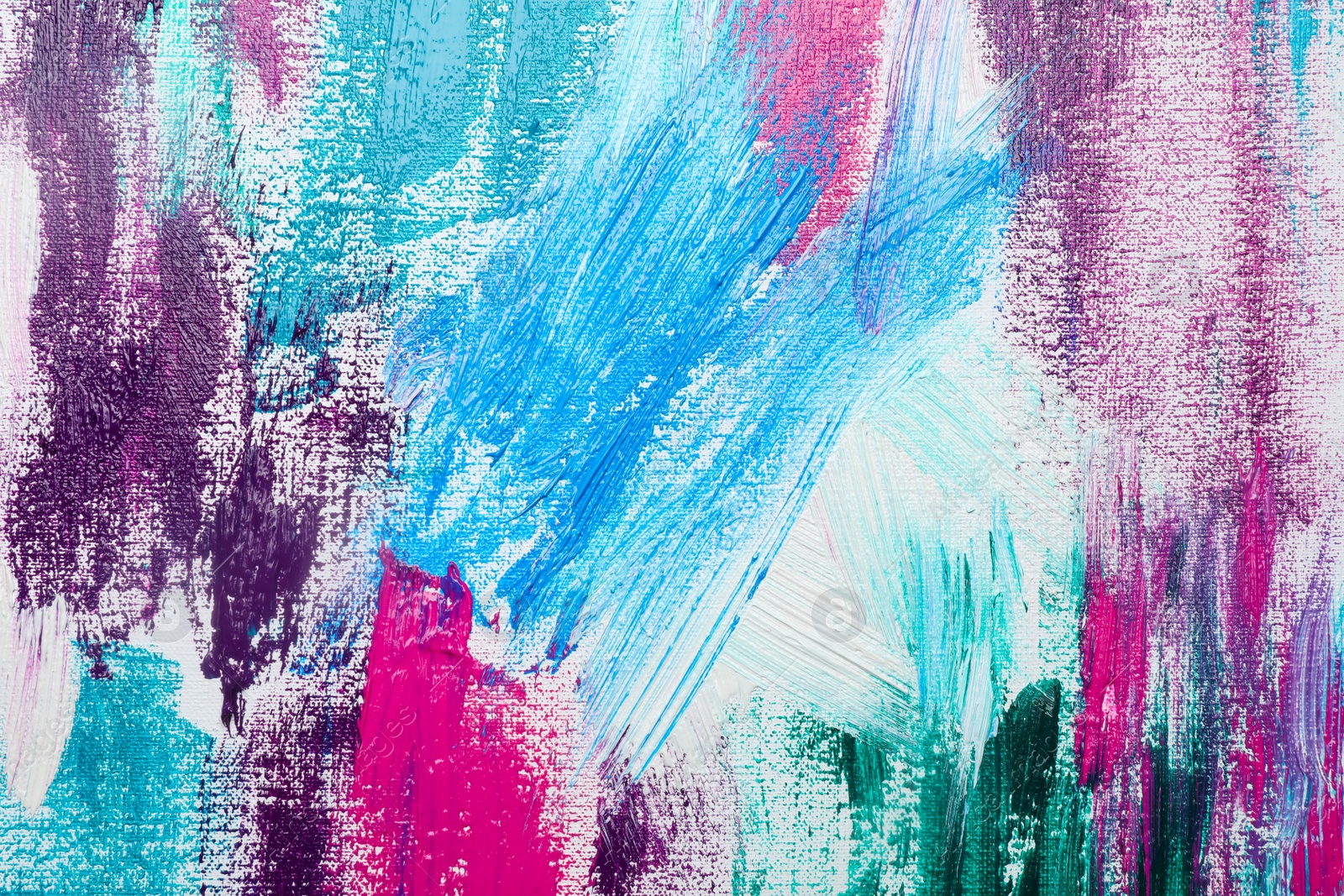 Photo of Strokes of colorful acrylic paints on white canvas, closeup