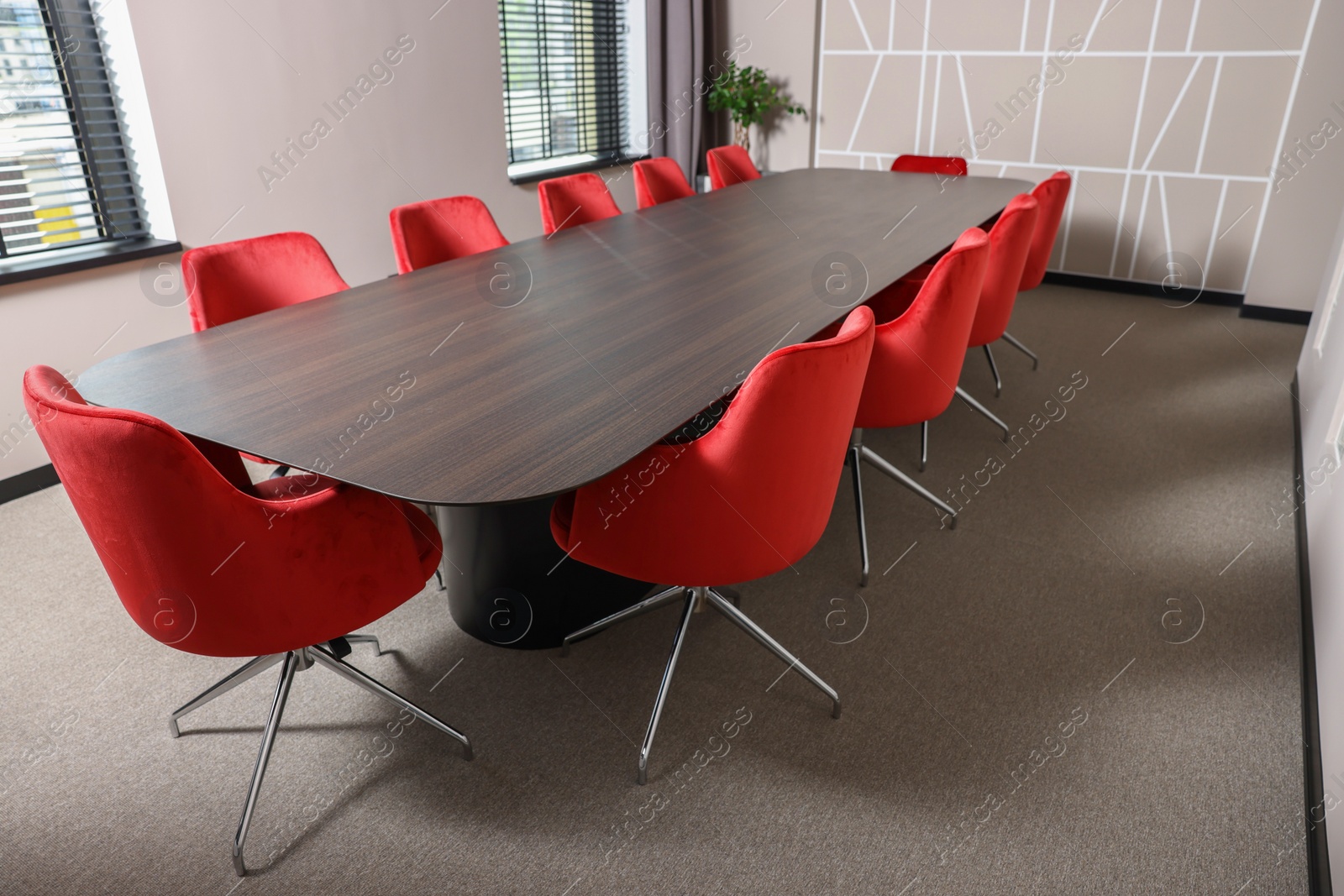 Photo of Empty conference room with stylish red office chairs and large wooden table