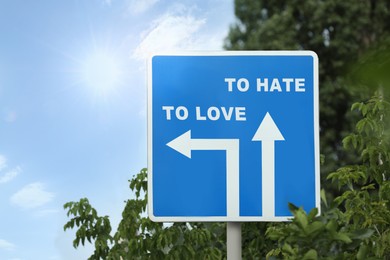 Road sign with different directions - TO HATE or TO LOVE outdoors