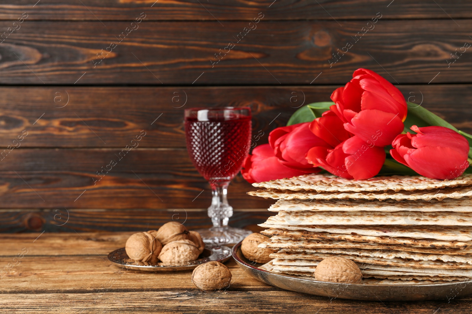 Photo of Composition with Passover matzos on wooden table, space for text. Pesach celebration