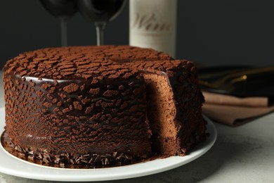 Photo of Delicious chocolate truffle cake on grey table, closeup