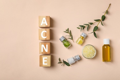 Cubes with word "Acne" and ingredients for homemade problem skin remedy on light background