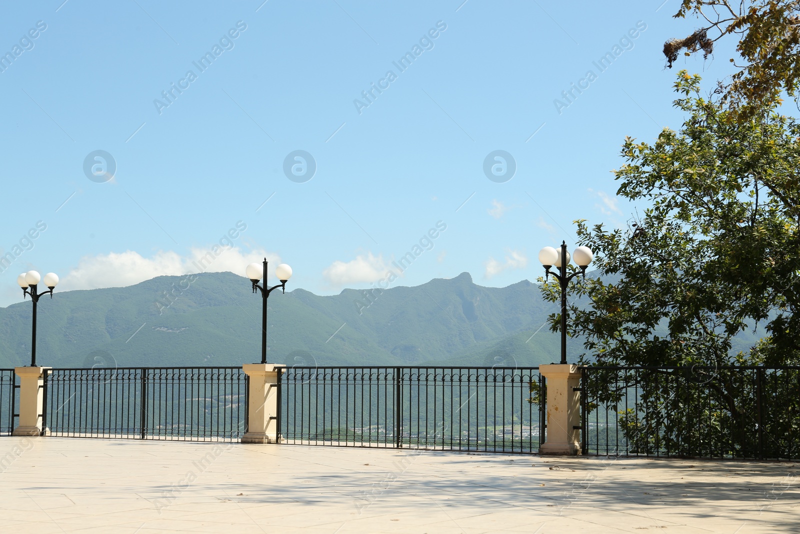 Photo of Beautiful mountains from viewpoint with fence and lamps