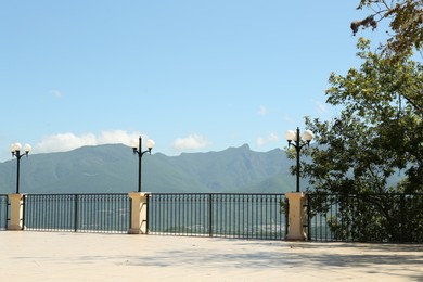 Photo of Beautiful mountains from viewpoint with fence and lamps