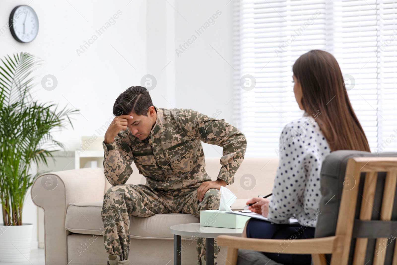 Photo of Psychotherapist working with male military officer in office