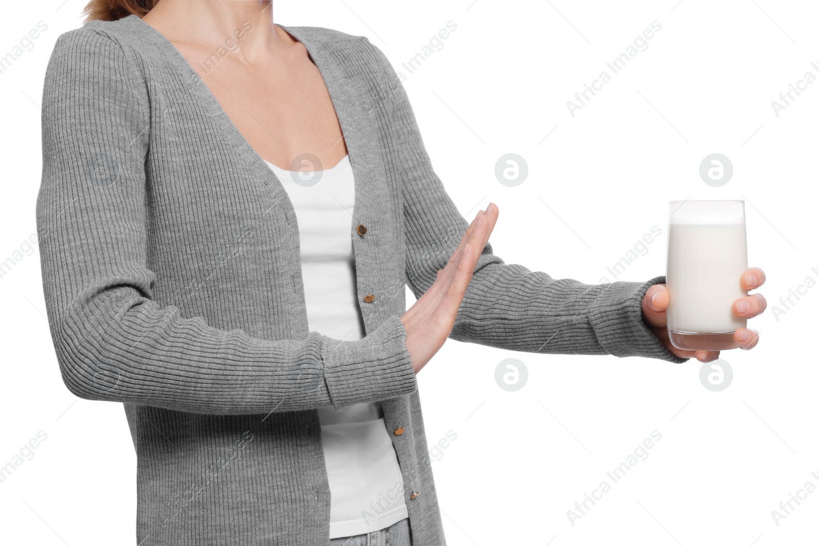 Photo of Woman with glass of milk suffering from lactose intolerance on white background, closeup