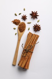 Photo of Cinnamon sticks, star anise and cardamom pods on white background, flat lay