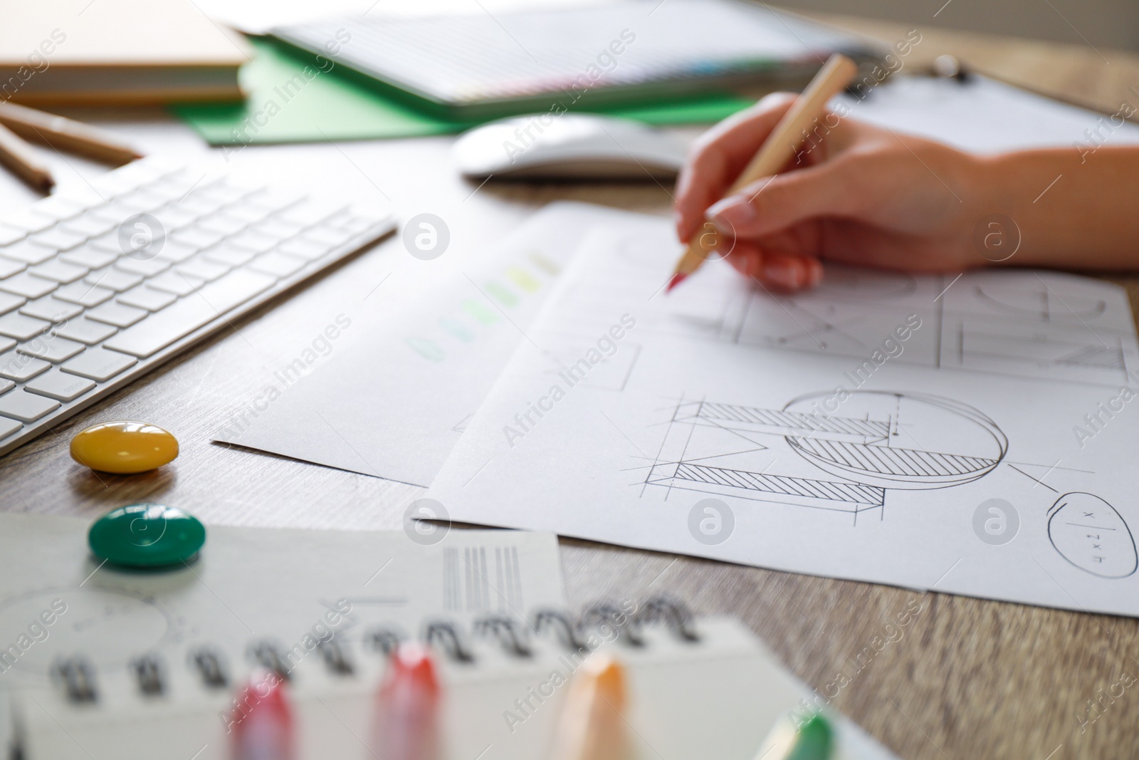 Photo of Female designer working at wooden table, closeup