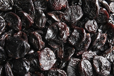 Photo of Tasty prunes as background, top view. Dried fruit as healthy snack