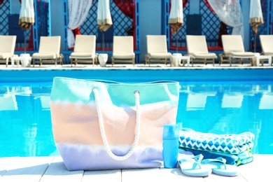 Beach accessories on wooden deck near swimming pool