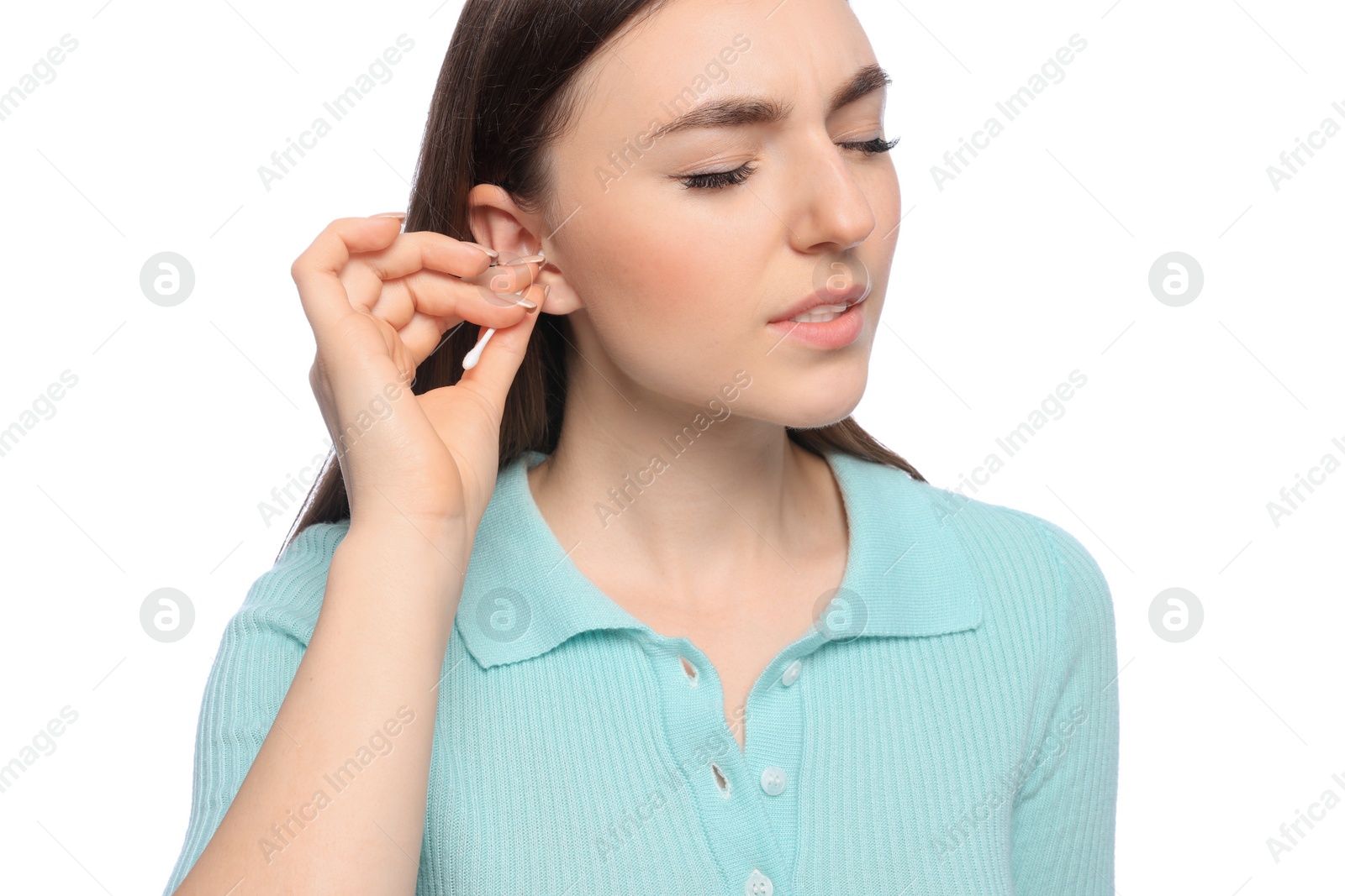 Photo of Young woman cleaning ear with cotton swab on white background, closeup