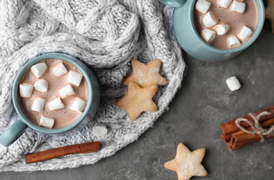 Photo of Composition with delicious hot cocoa drink and cookies on dark grey background, flat lay