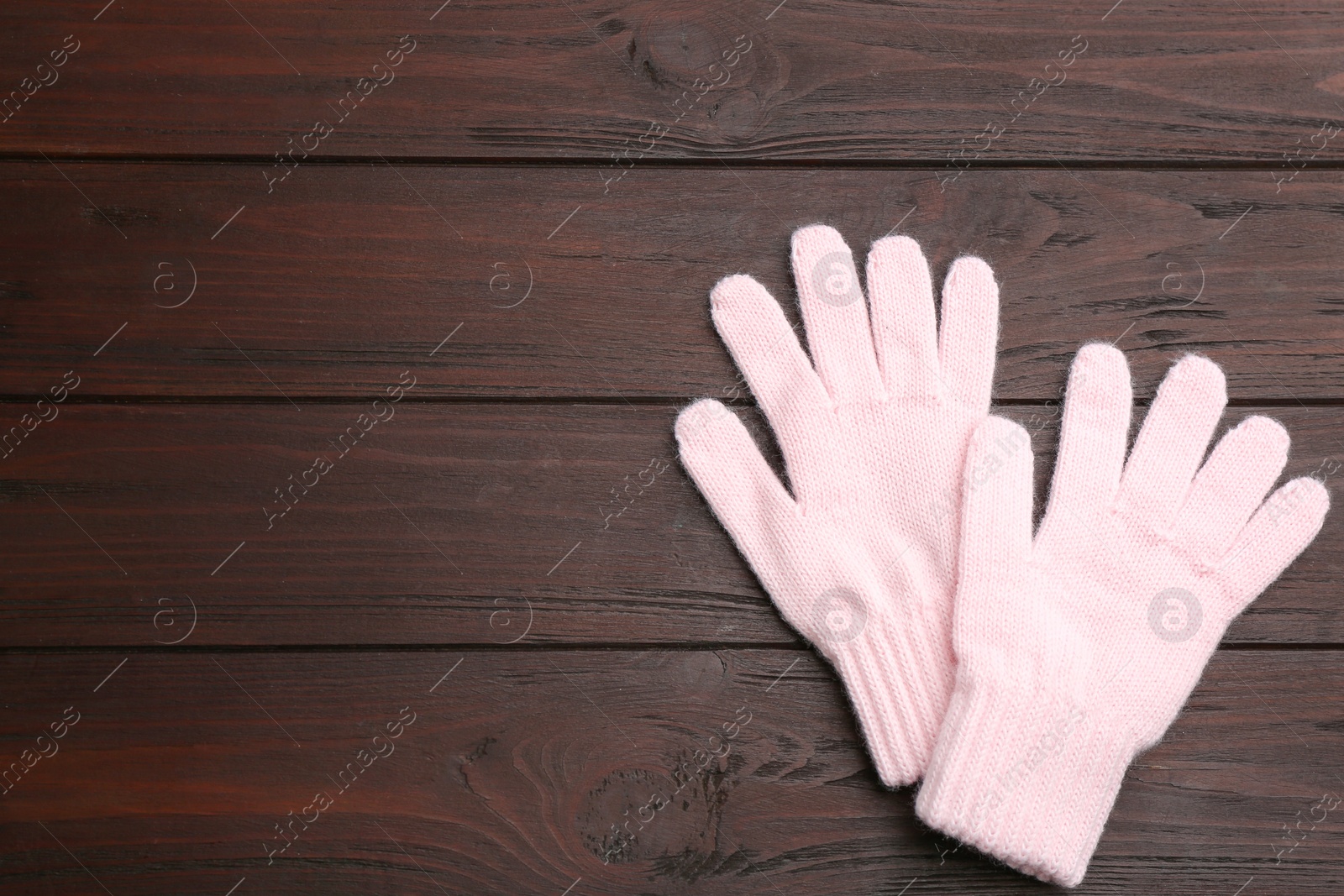 Photo of Stylish pink gloves on wooden background, flat lay. Space for text