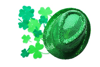 Photo of Leprechaun's hat and decorative clover leaves on white background, top view. St. Patrick's day celebration