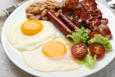 Photo of Delicious breakfast with sunny side up eggs on light table, closeup