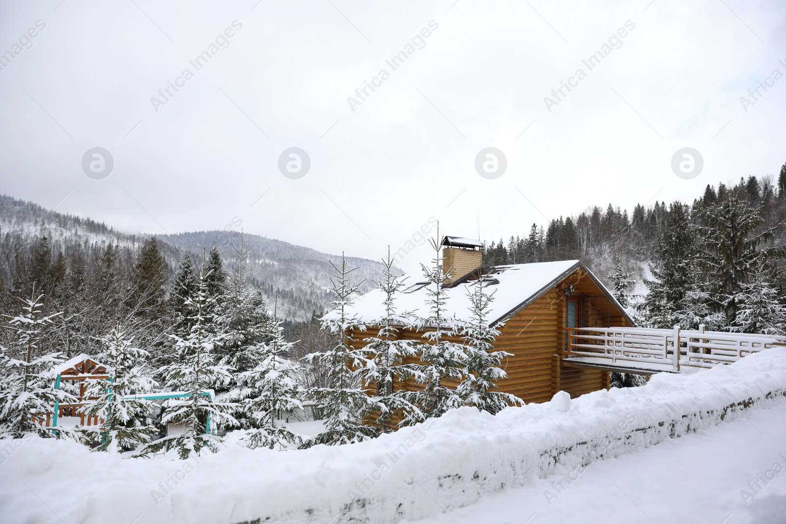 Photo of Beautiful landscape with cottage on snowy winter day