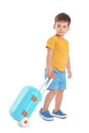 Photo of Cute little boy with blue suitcase on white background