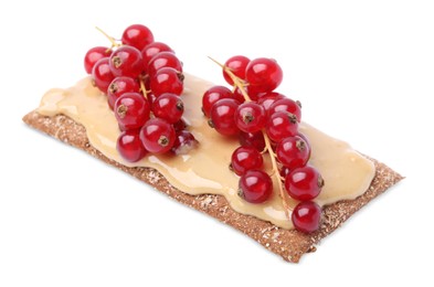 Photo of Fresh crunchy rye crispbread with peanut butter and red currant isolated on white