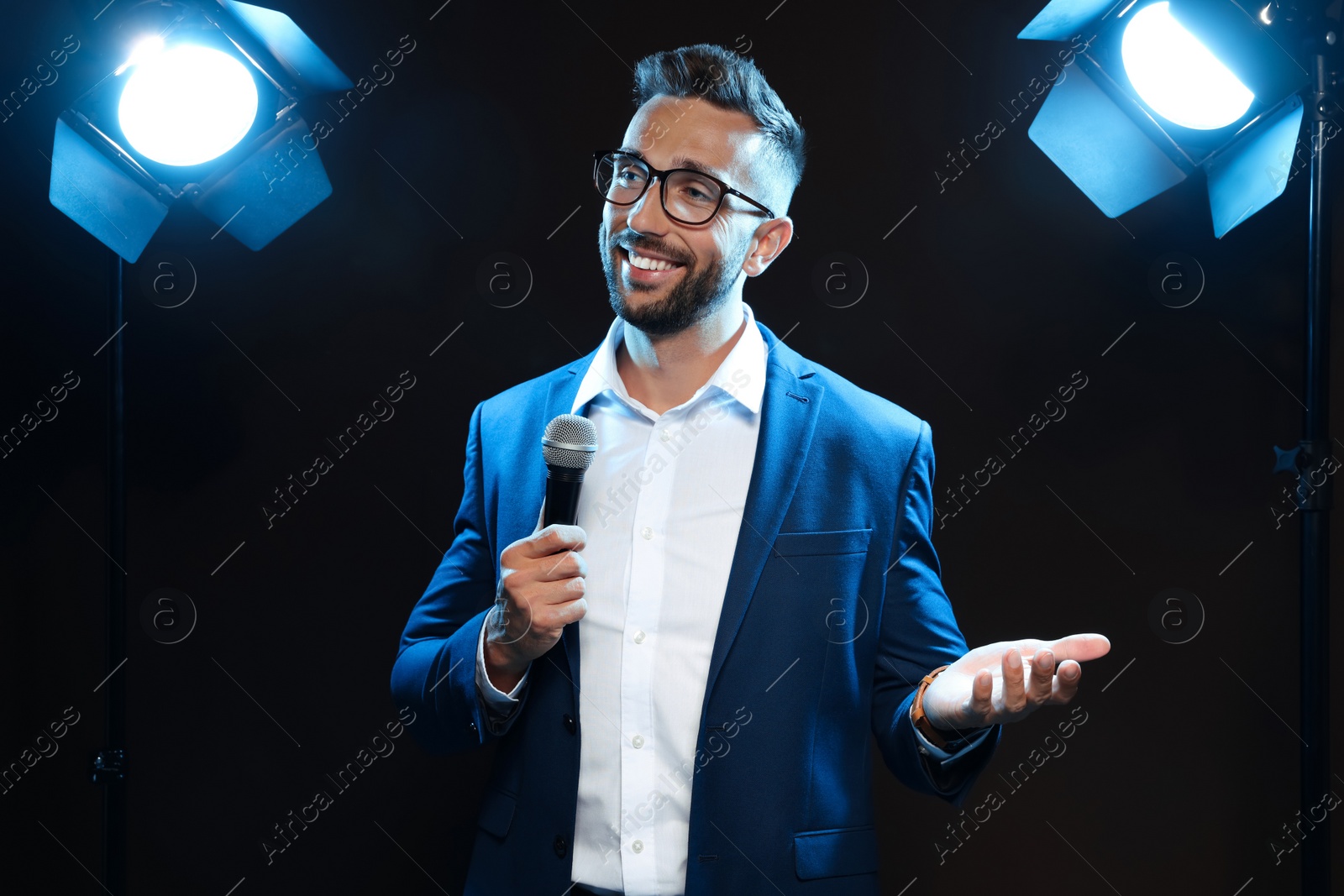 Photo of Motivational speaker with microphone performing on stage