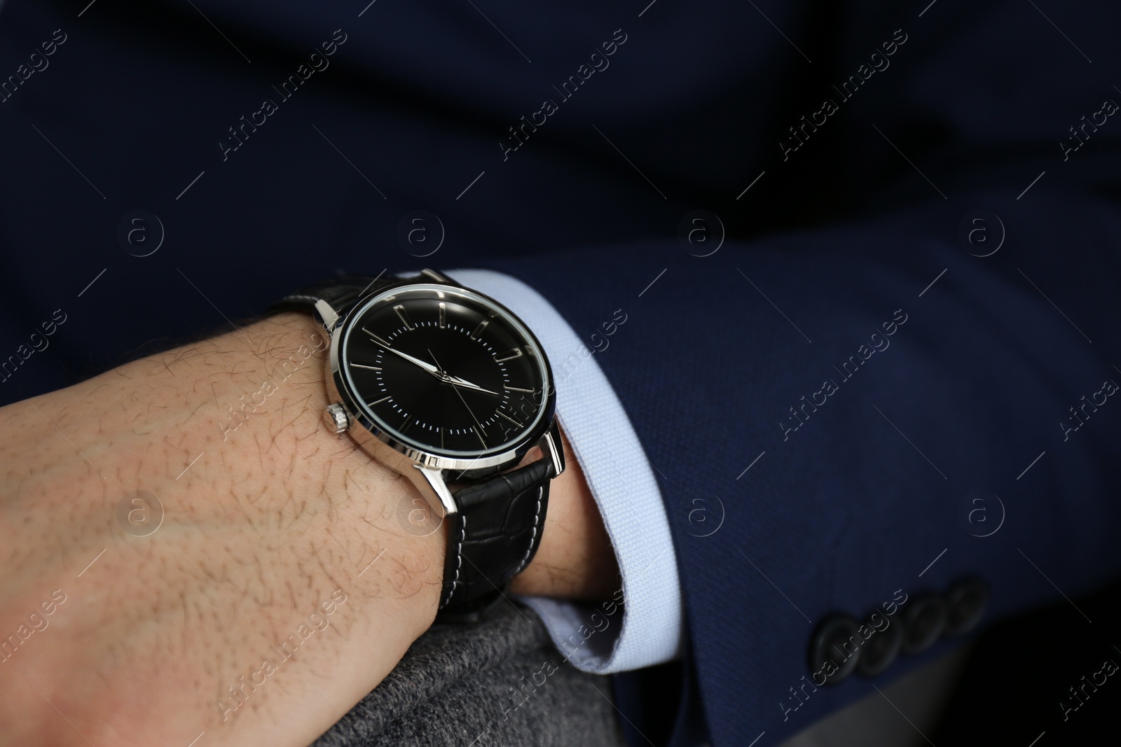 Photo of Businessman in jacket with luxury wrist watch, closeup