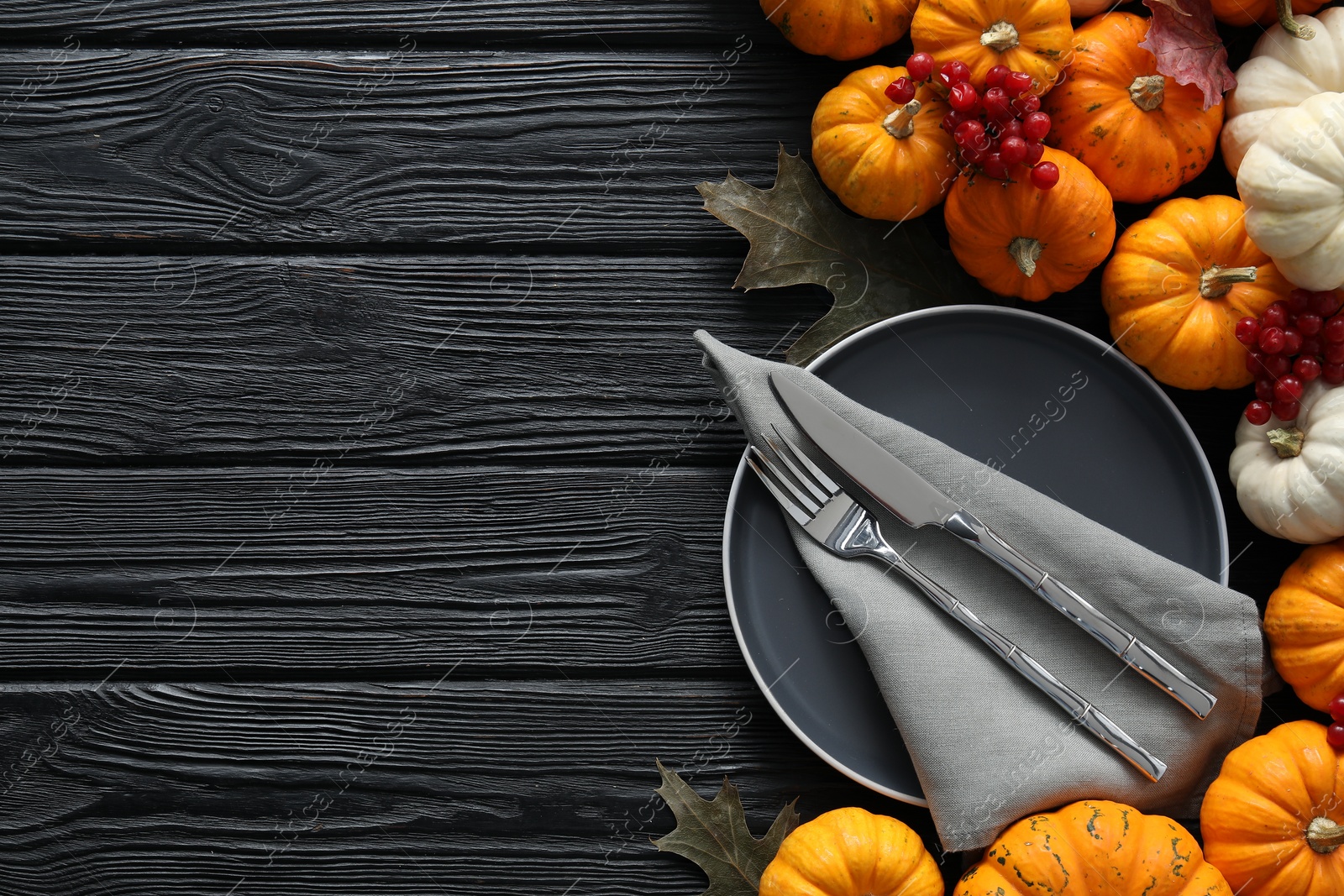 Photo of Happy Thanksgiving day. Beautiful table setting with autumn leaves, berries and pumpkins, flat lay, Space for text