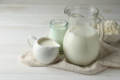 Photo of Lactose free dairy products on white wooden table, closeup