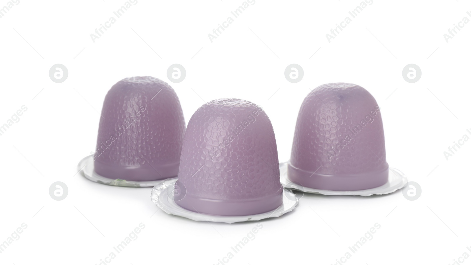 Photo of Delicious violet jelly cups on white background