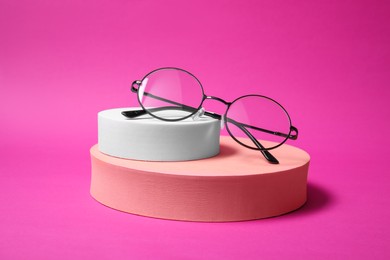Photo of Stylish presentation of glasses on pink background