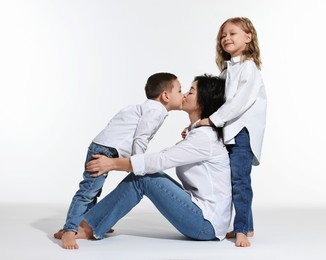 Little children with their mother on white background