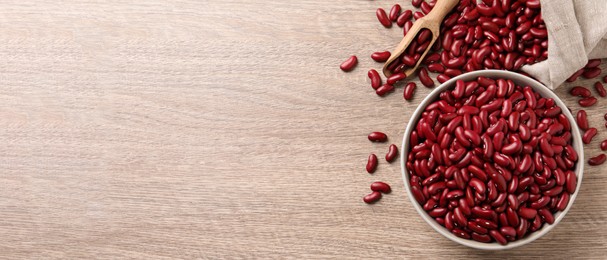 Red kidney beans and space for text on wooden table, flat lay. Banner design