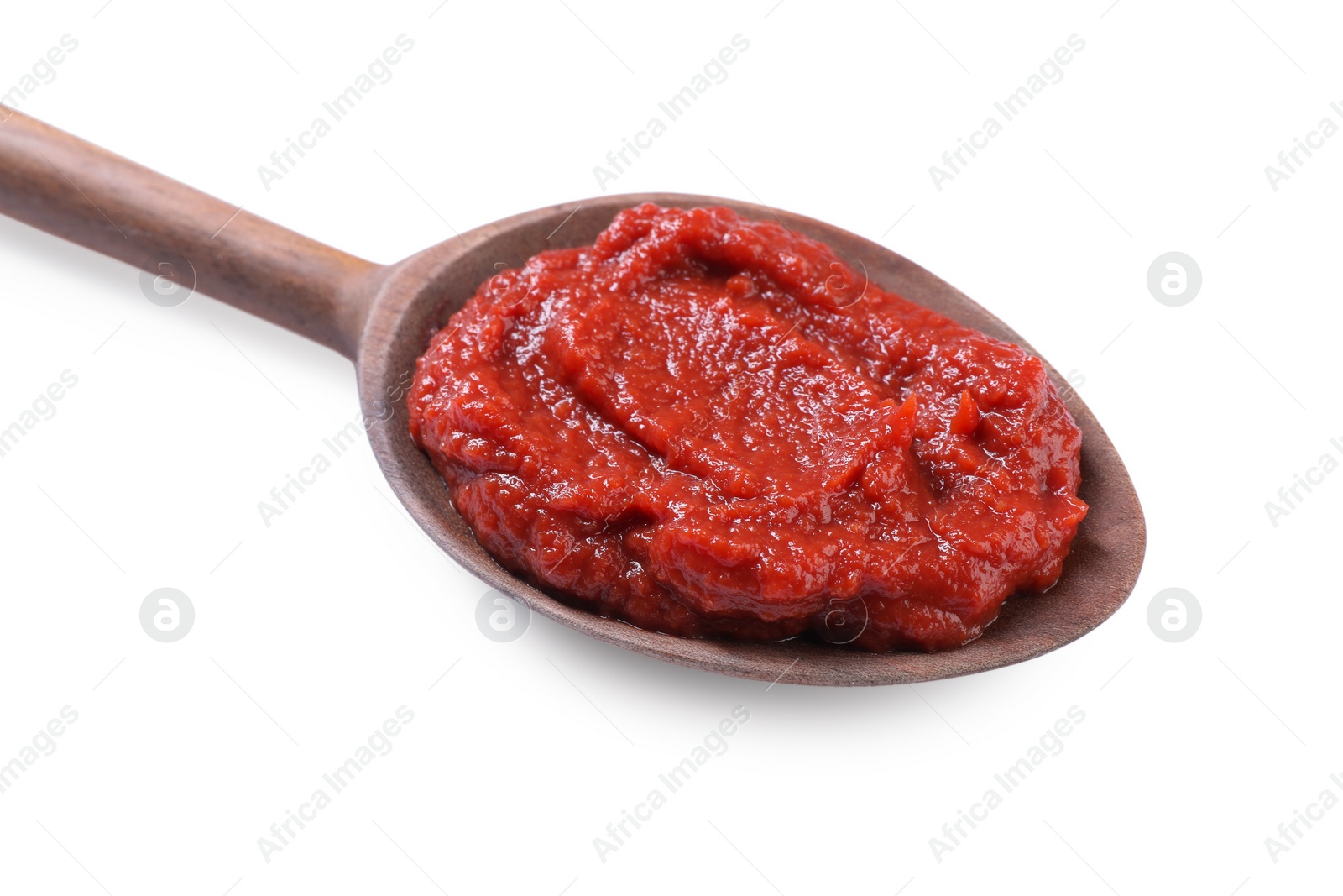 Photo of Wooden spoon of tasty tomato paste isolated on white