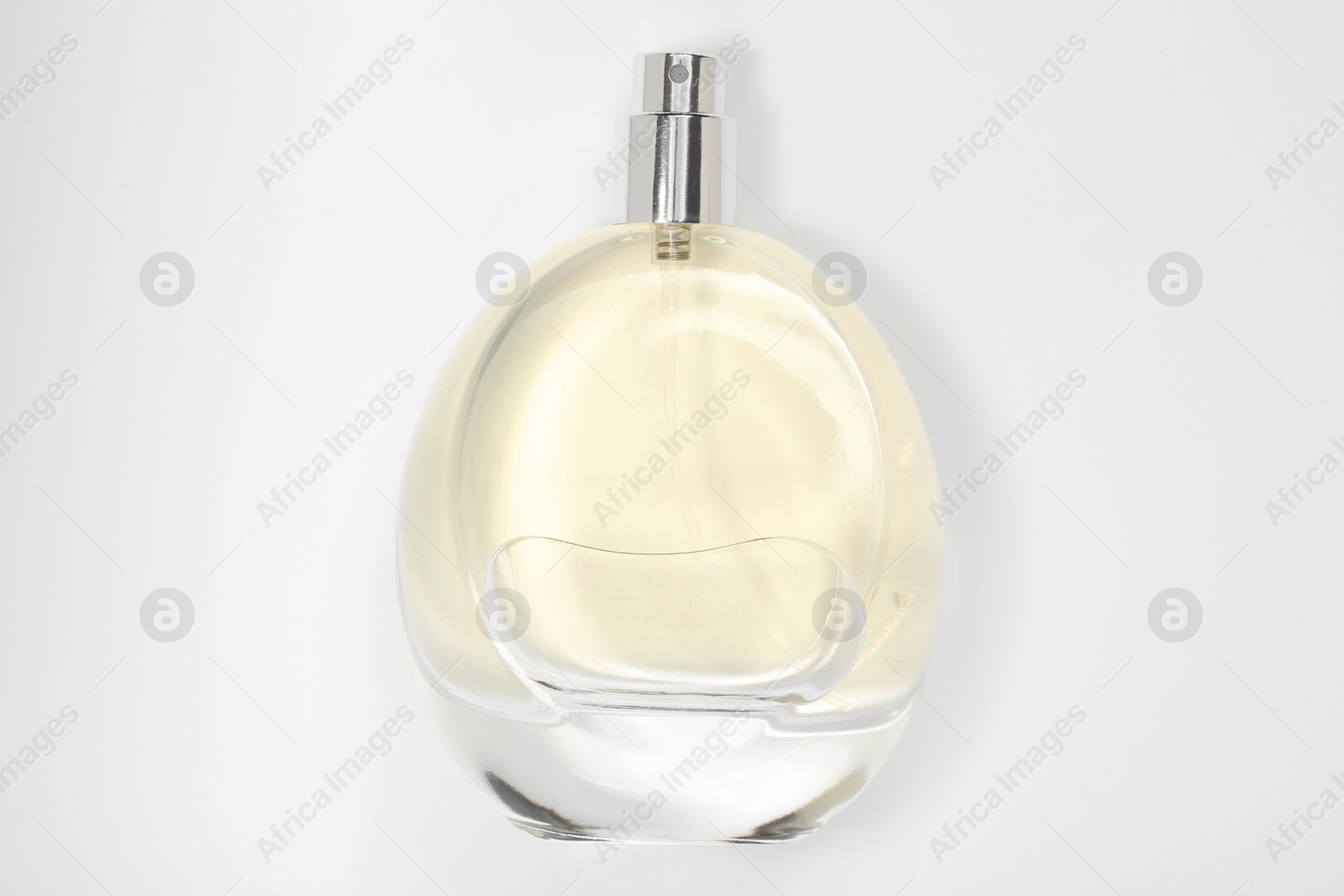 Photo of Luxury women's perfume in bottle on white background, top view