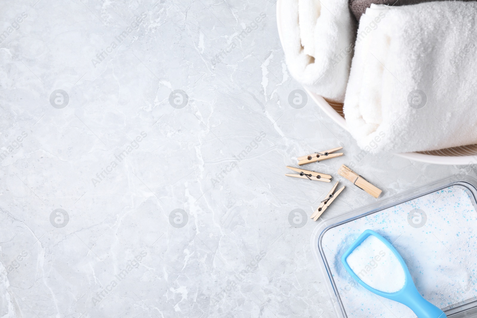 Photo of Flat lay composition with clean towels and laundry powder on marble background. Space for text