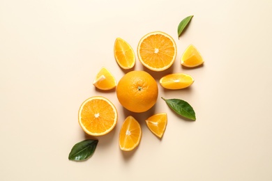 Flat lay composition with ripe oranges on color background