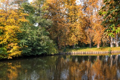 Picturesque view of river and trees in beautiful park. Autumn season