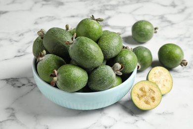 Fresh green feijoa fruits on white marble table, closeup