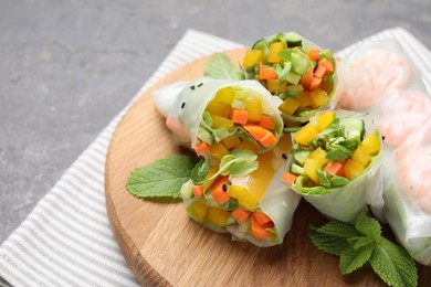 Photo of Tasty spring rolls on grey table, closeup. Space for text