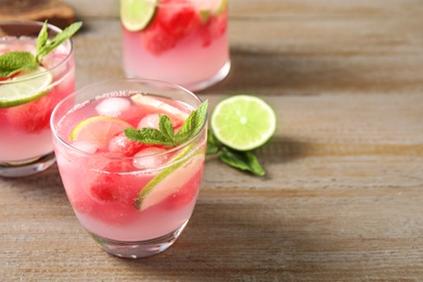 Photo of Tasty refreshing watermelon drink on wooden table. Space for text
