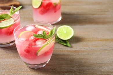 Tasty refreshing watermelon drink on wooden table. Space for text