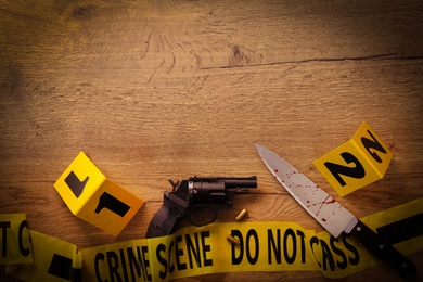 Photo of Flat lay composition with evidences on wooden background, space for text. Crime scene
