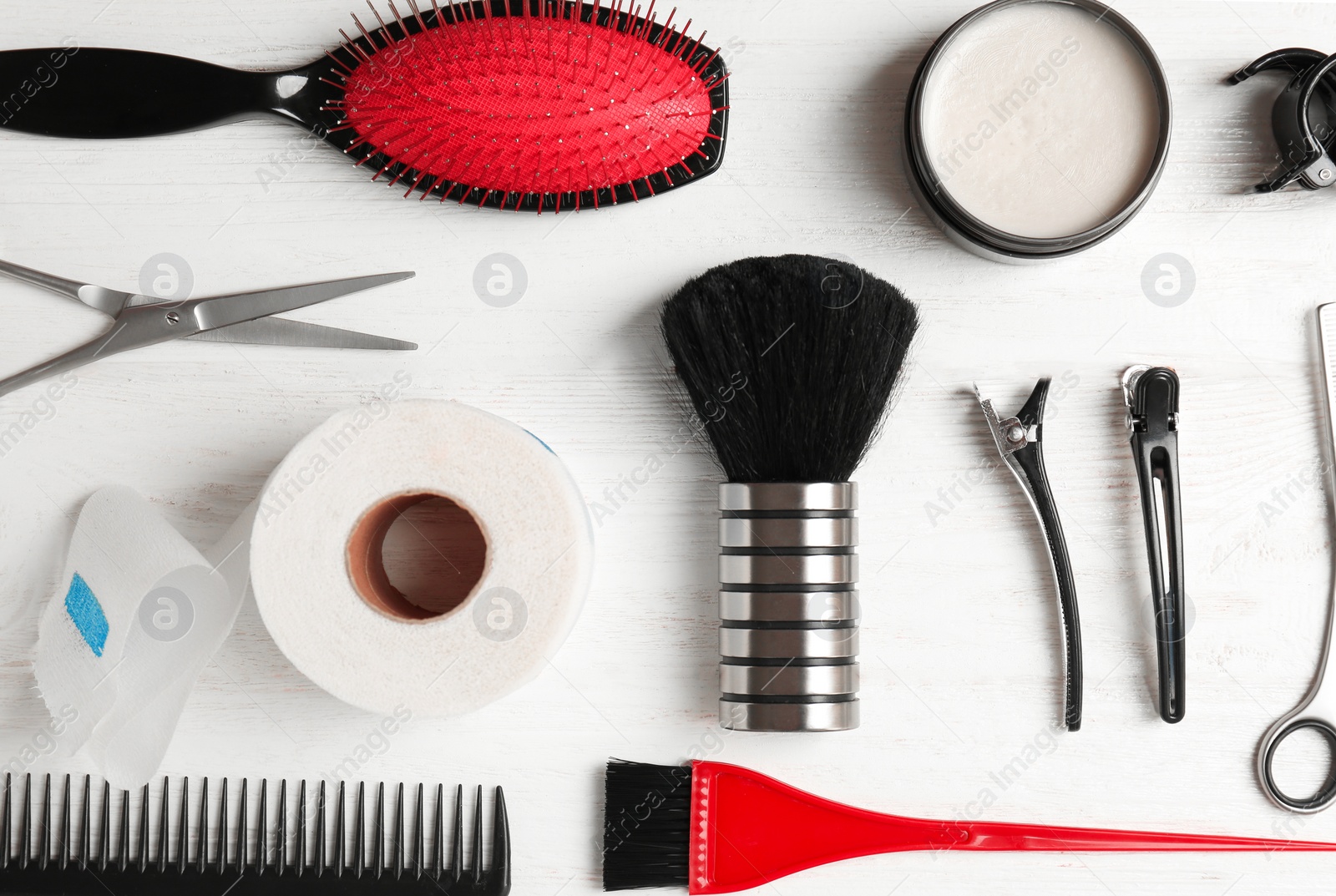 Photo of Flat lay composition with professional hairdresser tools on wooden background