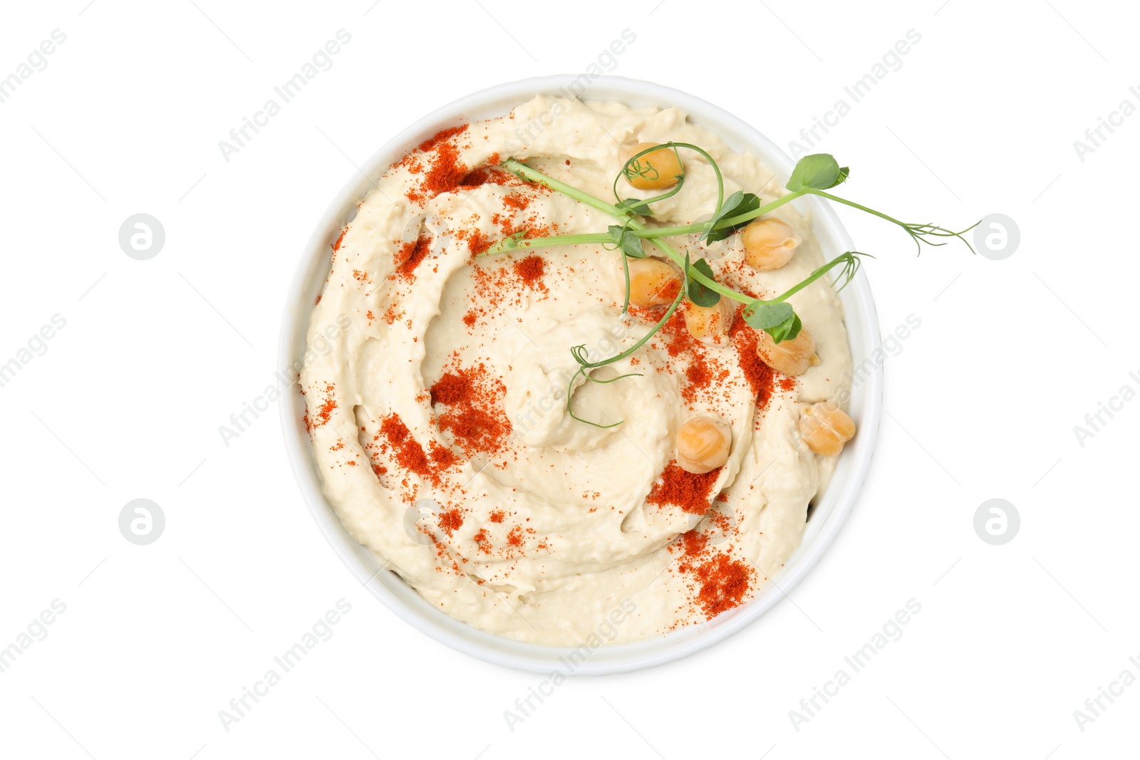 Photo of Bowl of delicious hummus with chickpeas and paprika isolated on white, top view